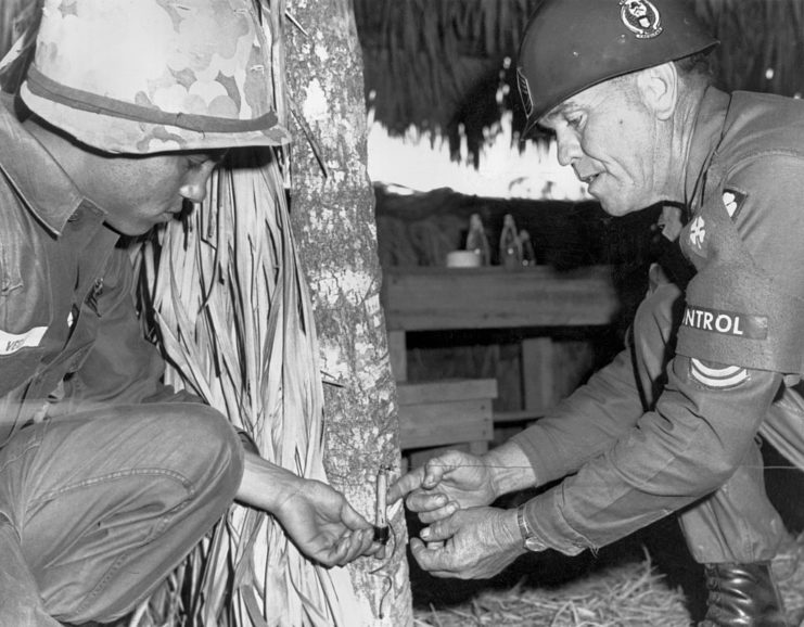 US Army instructor teaching a student how to deactivate a tripwire