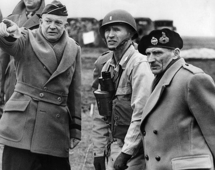Dwight D. Eisenhower standing with Bernard Montgomery and an unidentified man