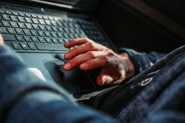 Hands using the scrolling mouse on a laptop