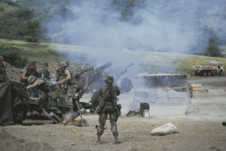 US soldiers firing M102 howitzers