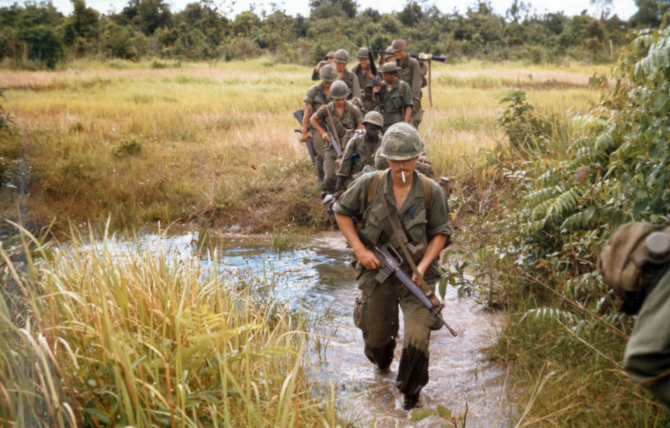 US soldiers crossing a stream