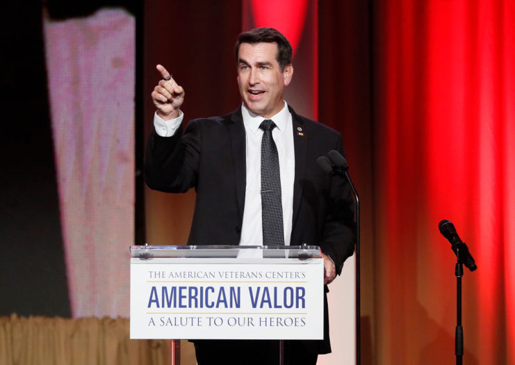 Rob Riggle speaking at a podium