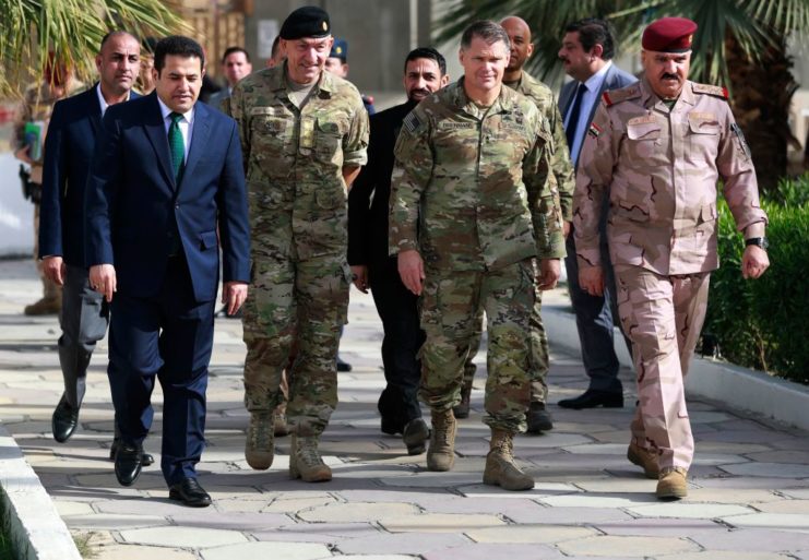 Qassem al-Araji, Michael Lollesgaard, John W. Brennan and Abdul Ameer al-Shammari walking together