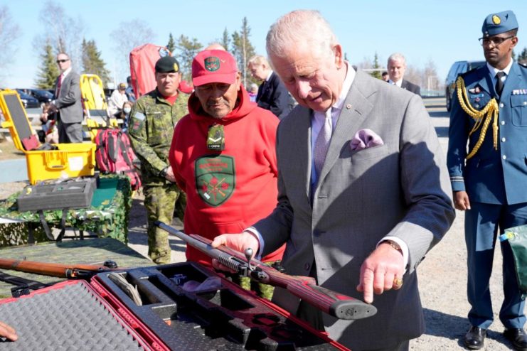 Prince Charles looks at a Colt Canada C19 rifle