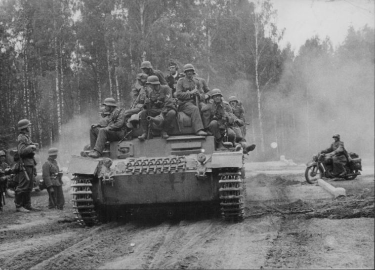 German soldiers sitting atop a tank