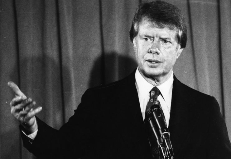 Jimmy Carter speaking at a podium