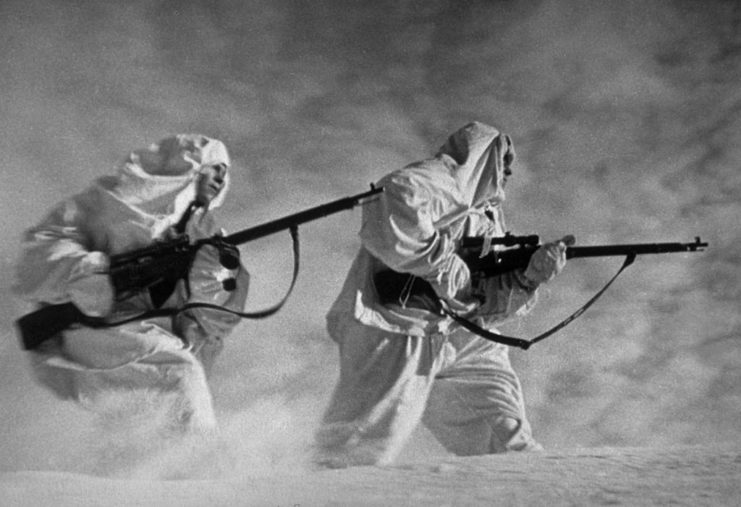 Two Russian snipers walking through blowing snow
