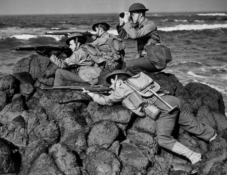 American troops positioned on a pile of large rocks