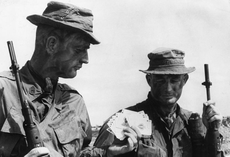Two US Marine Corps sergeants holding ace of spades