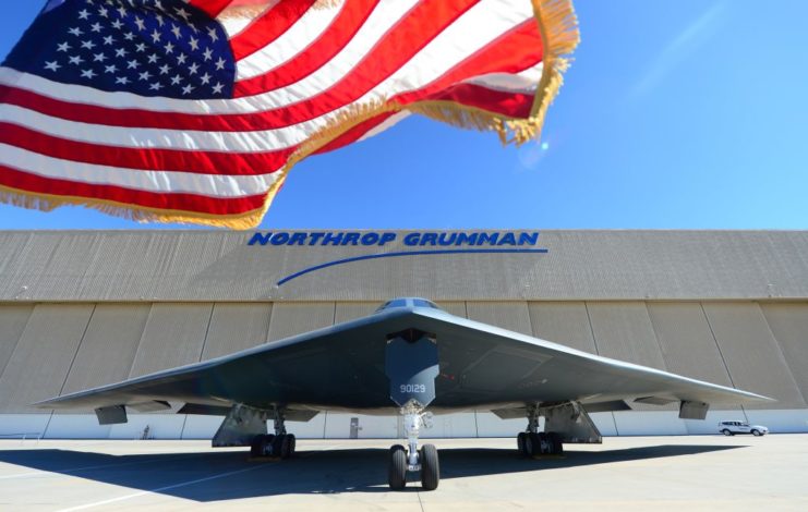 Northrop Grumman B-2 Spirit parked beneath the American flag