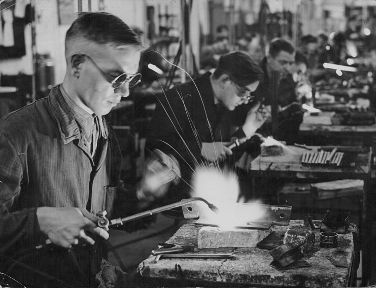 Factory worker welding a piece of metal