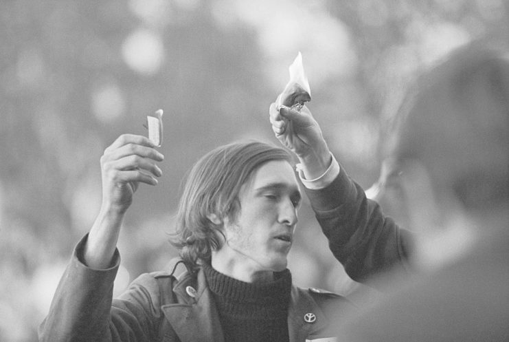 Protesters burn draft cards during an anti-war demonstration 