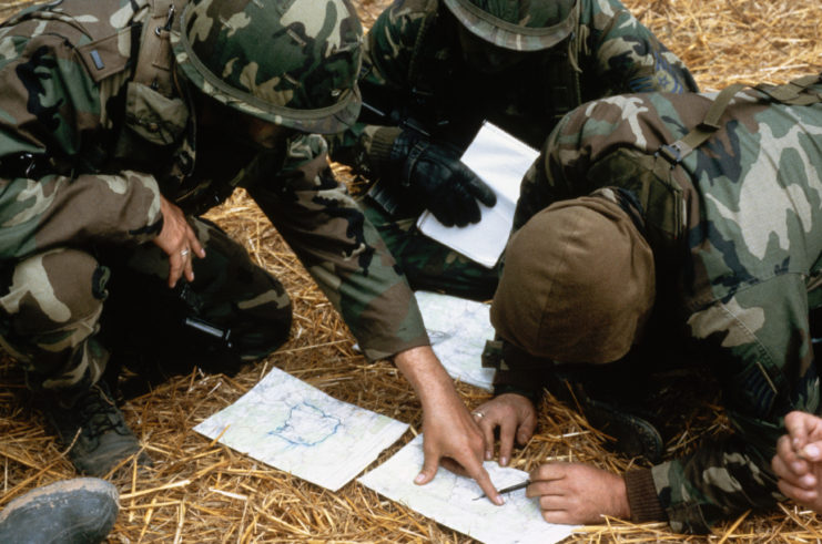 US soldiers bent over maps of Grenada