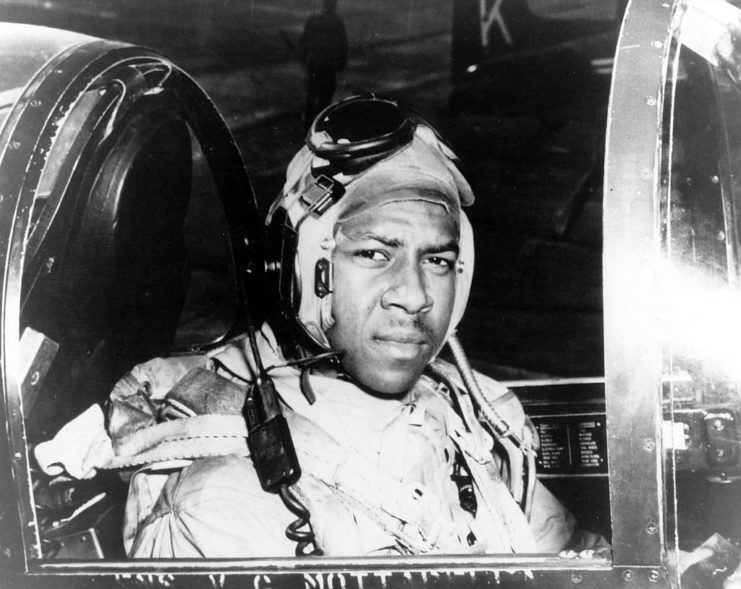 Jesse L. Brown sitting in the cockpit of a Vought F4U-4 Corsair