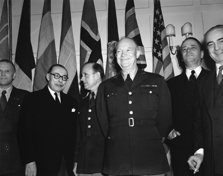 Dwight D. Eisenhower standing with deputies of the North Atlantic Treaty Organization