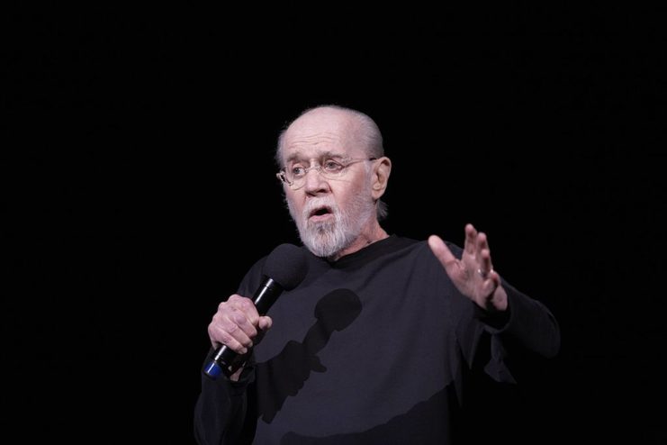 George Carlin performing on stage