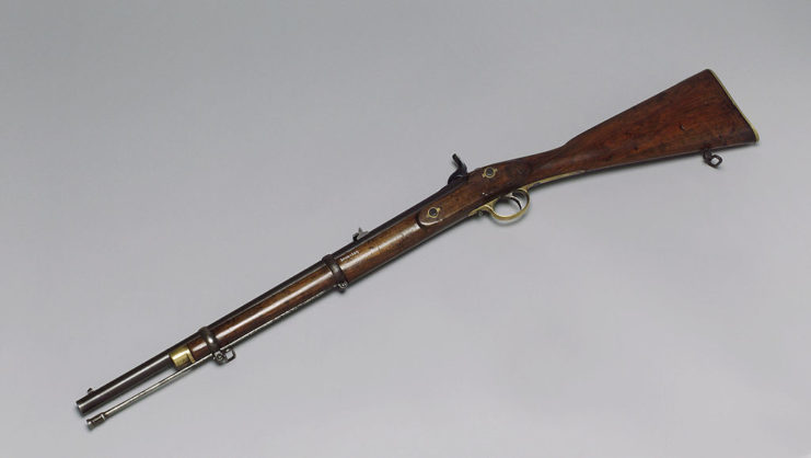 Lee-Enfield repeating rifle on a white tabletop