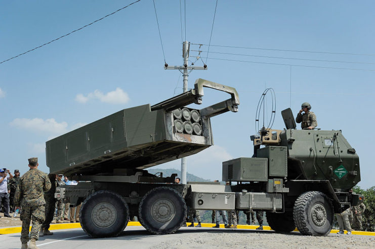 Soldiers standing around an M142 HIMARS