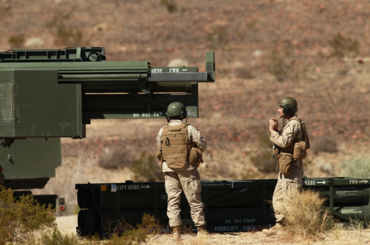 Two Marines loading an M142 HIMARS