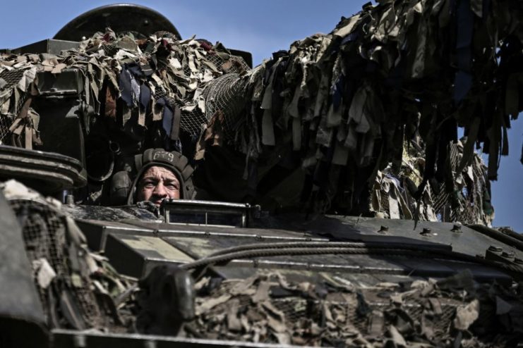 Ukrainian soldier sitting in a tank