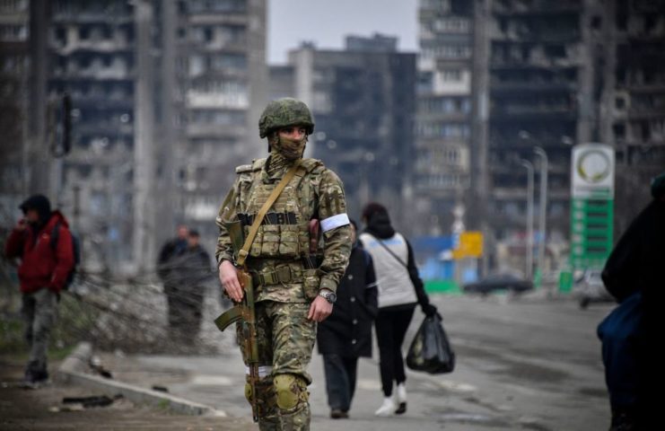 Russian soldier standing in the middle of a street in Mariupol