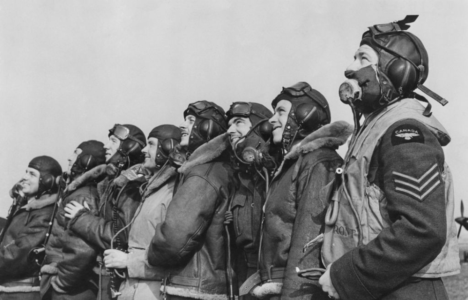 Eight RAF pilots standing together in their uniforms