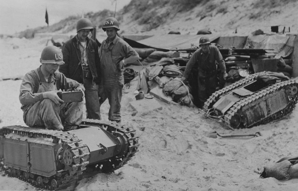 US Navy sailors standing around captured Goliath tracked mines