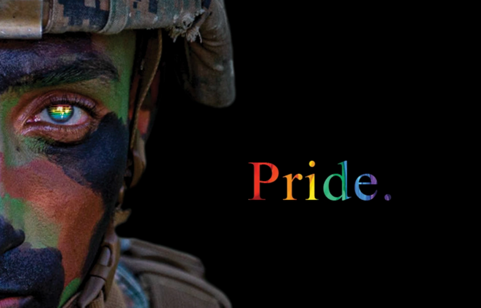US Marine in camouflage + "Pride" written in rainbow lettering