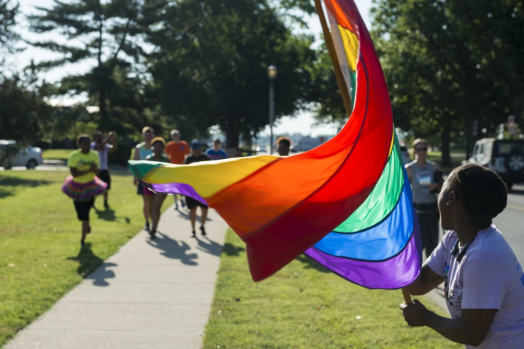 Senior Airman Kiana Brothers waving the Pride flag