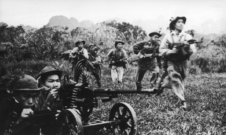 Viet Cong guerrillas running with weapons
