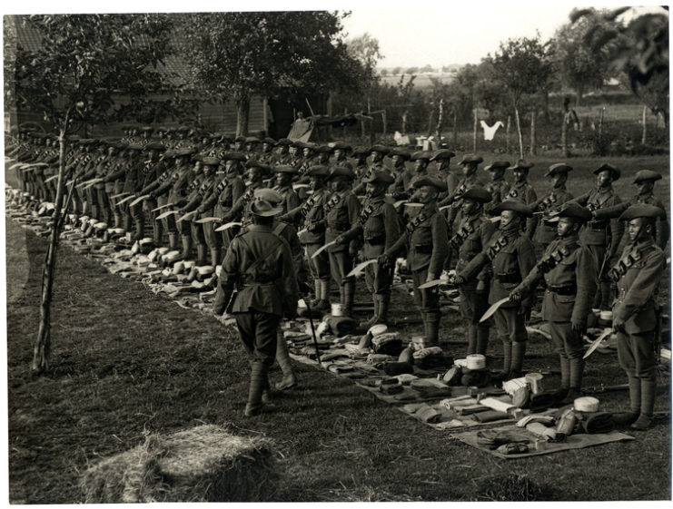 Gurkhas standing in formation while holding out their Kukri blades