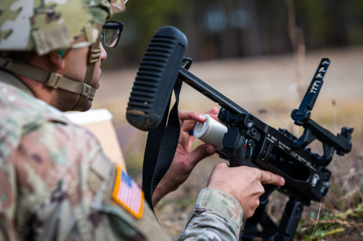US Army soldier holding an M320 grenade launcher