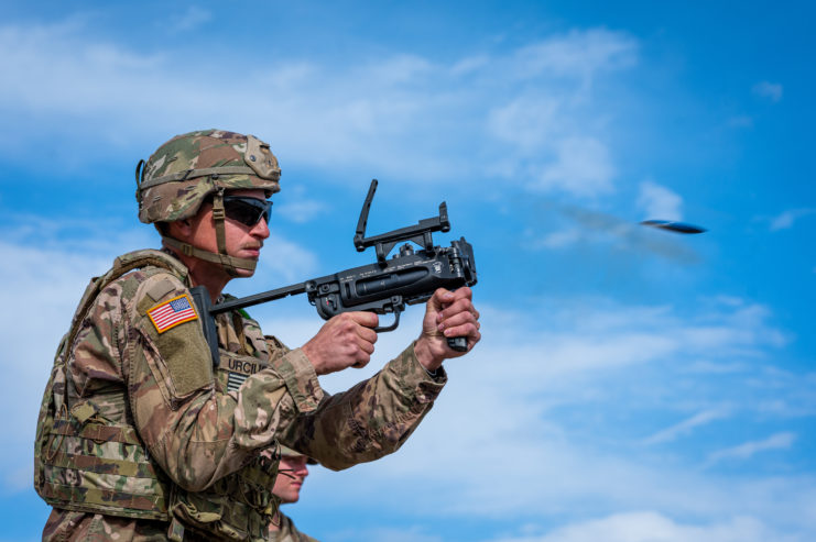 US Army soldier firing an M320 grenade launcher