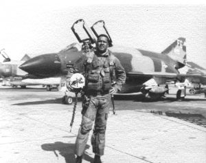 Gen. Daniel James Jr. wearing his fighter pilot uniform while standing outside of his aircraft