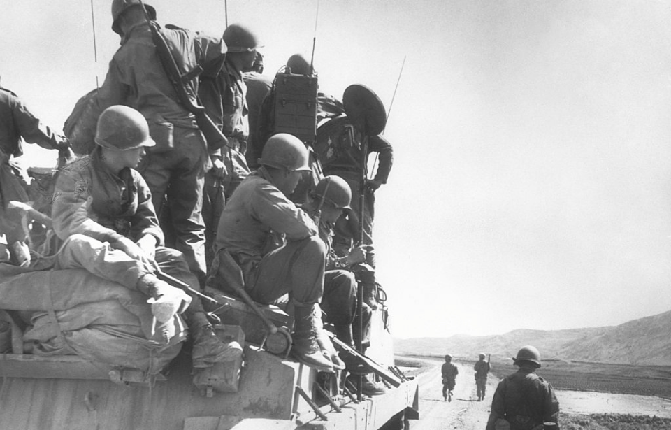 US infantrymen sitting on top of a tank