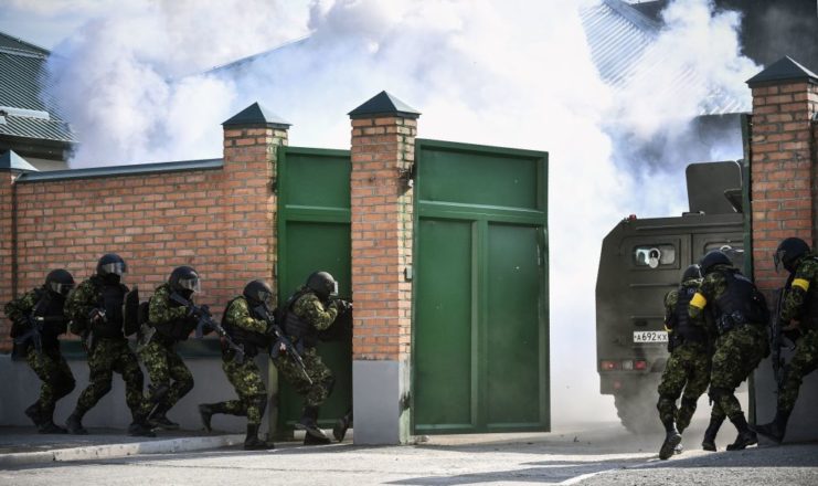 Chechen Special Forces troopers aiming through an open gate