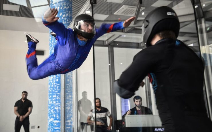 Man floating in an aerodynamic tube