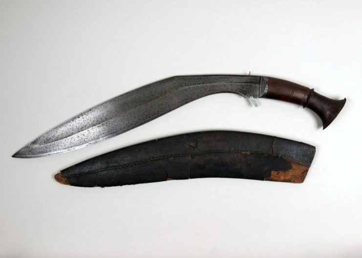 Kukri blade and sheath on a white tabletop