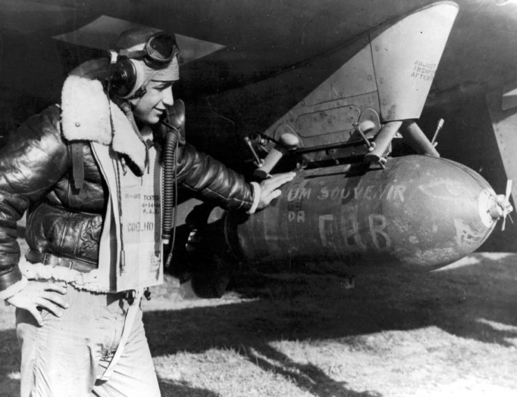 Brazilian flyer lieutenant looking at an aircraft bomb