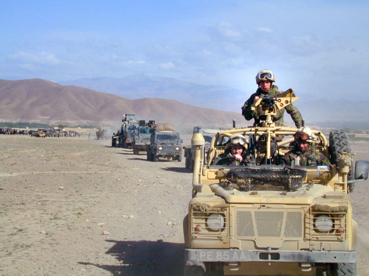 Convoy of British armored and military vehicles driving in the desert