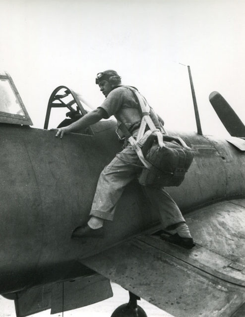 Gregory "Pappy" Boyington standing on the wing of a Vought F4U Corsair
