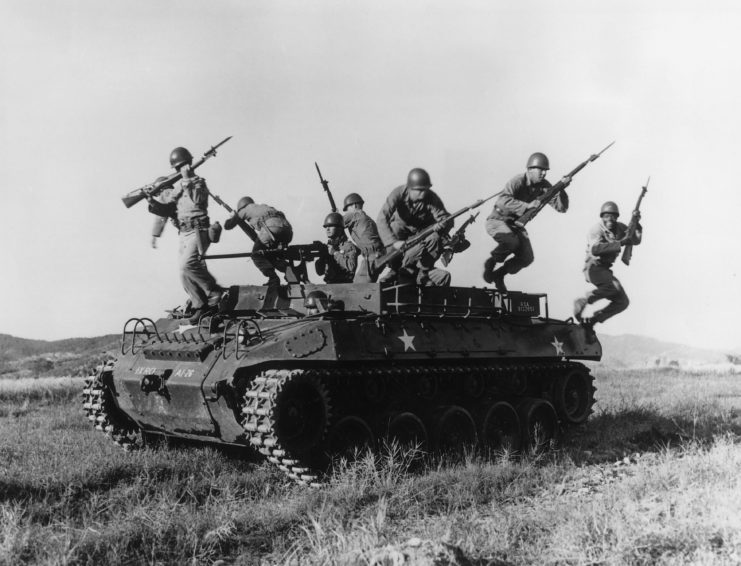 US soldiers leaping from a tank