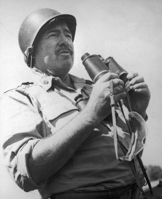Ernest Hemingway holding a pair of binoculars