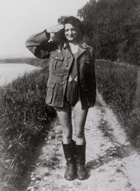 Woman saluting while wearing a German military uniform