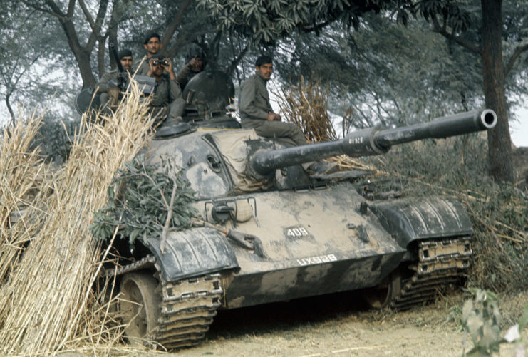 Indian soldiers sitting atop a tank