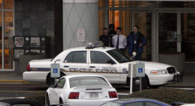 Police officers leading a man to a cruiser