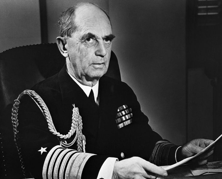 William Leahy reading over papers at his desk