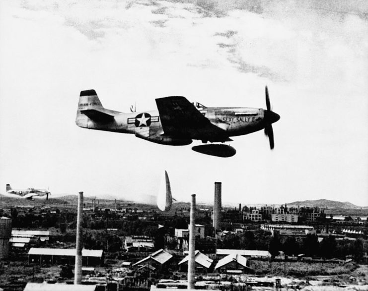 North American P-51 Mustang releasing a drop tank mid-flight