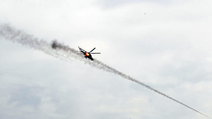 Mil Mi-24 Hind firing a missile mid-flight