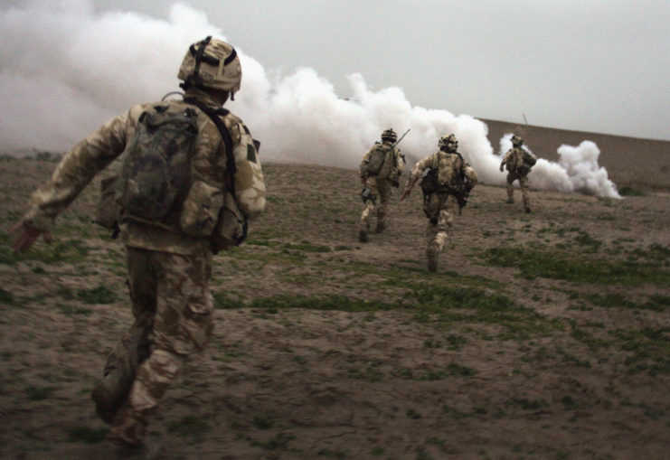 British Royal Marines running through a field